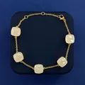 Gold chain bracelet with five square white chalcedony gemstones in a circular layout - Gold Tone + White Jade