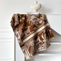 Detail of cashmere feel scarf with animal Toile de Jouy pattern and fringe trim - Brown