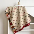 Détail d'une écharpe beige en cachemire avec motifs de chevaux colorés et franges - Beige