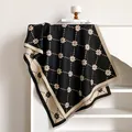 Detail of floral polka dot pattern and tassel fringe on a thick winter cashmere scarf - 200x65cm / Black