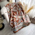 Elegant paisley print shawl with fringe tassels in brick red and blue on a chair - 185x65cm / Brown