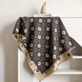 Close-up of floral cashmere feel scarf with tassels hanging on a white cabinet - 185x65cm / Gray