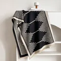 Close-up detail of soft knitted geometric pattern scarf with black and white texture - 185x65cm / Black