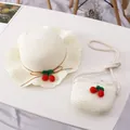 Detail of kids straw hat and matching crossbody bag with crochet cherry decorations - Cherry Single Hat / Cream