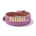 Detail view of pink double-wrap leather bracelet with polished gold metal accents and buckle - Pink