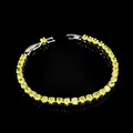 Macro shot of silver-tone tennis bracelet featuring round brilliant yellow cubic zirconia - Silver Yellow