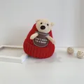 Detail of red knit baby winter hat with cute plush bear ears and soft bear patch - Infant Size / Red