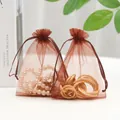 Brown organza drawstring pouches for jewelry packaging with pearl necklace and gold rings - Coffee