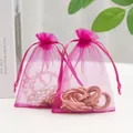 Rose red organza drawstring jewelry bags featuring pearl bracelet and gold accessory - Rose Red