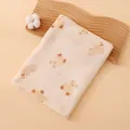 Folded cotton muslin swaddle blanket featuring a cute bear print on wavy wooden tray - 100x100cm / Hug Bear