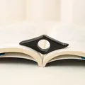 Glossy black acrylic thumb book page holder with ergonomic wing shape for reading - Black / 8.5cm
