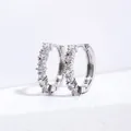 Macro shot of silver hoop earrings with clear cubic zirconia pavé setting on white background - Silver + White Zirconia