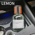 Lemon scented car air freshener with glass bottle and wooden lid in car cup holder - Car Lemon