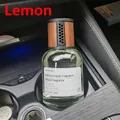 Lemon scented car air freshener with glass bottle and wooden lid in car cup holder - Car Lemon