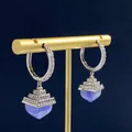 Macro shot of silver drop earrings with inlaid micro-diamonds and light blue blue-veined agate - Blue Lace Agate Pyramid Pendant Earrings / Silver