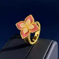 Macro detail of gold flower ring with red stone petals and beaded edge craftsmanship - Gold Pink Chalcedony Style