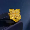 Golden flower ring with diamond clover design on luxury blue velvet jewelry box - Gold Guilloché Style