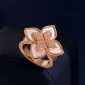 Macro detail of rose gold flower ring with white mother of pearl inlay and crystal pavé - Rose Gold White Shell Style