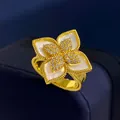 Macro shot of gold floral ring featuring mother of pearl petals and pavé diamond center - Gold White Shell Style