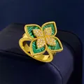 Macro detail of gold flower ring with green malachite stone and sparkling diamond pavé - Gold Malachite Style