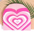 Pink Y2K knit beanie with heart gradient pattern on a wooden decorative background - One Size / Pink