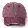 Vintage washed cotton baseball cap in wine red featuring green coconut tree embroidery - One Size / Burgundy
