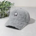 Detail of light gray plush baseball cap featuring a distinctive alien embroidery patch - Gray