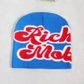 Blue knitted beanie featuring red and white Rich Mob jacquard lettering for autumn winter - Sapphire Blue