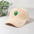 Detailed view of the plush apricot baseball cap with a green alien embroidery patch - Off White