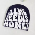Detail of navy knit beanie featuring white All We Need Is Honey jacquard text design - Navy Blue