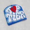 Detail of bright blue Y2K knit beanie with white Top Tier text and red broken heart pattern - Teal