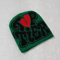 Detail of green Y2K beanie featuring a red broken heart and black Top Tier lettering - Green