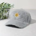 Détail d'une casquette en peluche grise avec une broderie de soleil jaune vif - Gris