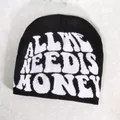 Detailed view of black knitted beanie featuring white 'ALL I NEED IS MONEY' slogan embroidery - Black