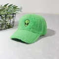 Detail of bright green plush baseball cap featuring a cute embroidered alien patch - Light Green