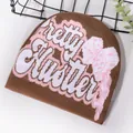 Brown knit beanie with pink letter jacquard and bow design for winter street style - One Size / Brown
