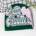 Dark green beanie featuring Pretty Hustler letter embroidery on white background - One Size / Dark Green