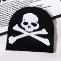 Y2K Gothic style black knitted beanie featuring a large white skull and crossbones pattern - One Size / Black
