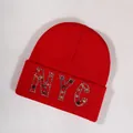 Red NYC knit beanie hat with vibrant multicolored rhinestone embellishments on the cuff - Red