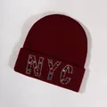 Burgundy knitted beanie featuring colorful rhinestone NYC letters on a folded cuff - Burgundy