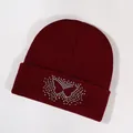 Burgundy knitted beanie featuring a colorful rhinestone butterfly on a folded cuff - Burgundy