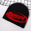 Detailed knit texture of a black beanie with red Desire lettering and jacquard patterns - Black/Red