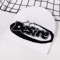 Detail shot of white knit beanie with black Desire lettering on a modern mesh backdrop - White/Black