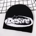 Macro detail of Desire jacquard knit pattern on black winter beanie with soft texture - Black/White