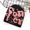 Streetwear knitted beanie featuring black and pink jacquard star and artistic font design - One Size / Black and Peach