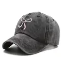 Washed denim baseball cap with pink bow embroidery and a curved brim for sun protection - One Size / Black