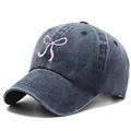 Vintage washed denim baseball cap with pink bow embroidery on charcoal gray fabric - One Size / Navy Blue