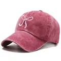 Vintage washed dark pink baseball cap with white bow embroidery and a soft top design - One Size / Burgundy