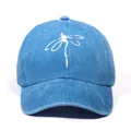 Blue washed denim baseball cap featuring a white dragonfly print with a curved brim - Blue