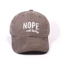 Washed cotton baseball cap in vintage coffee brown with white NOPE printed text - Coffee